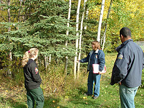 State and Mat-Su fire prevention officers discuss the removal of hazardous fuels.